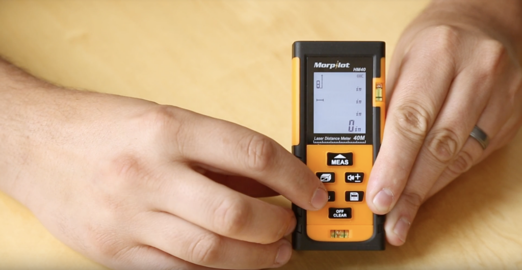 Hands Holding a Laser Measurement Tool 