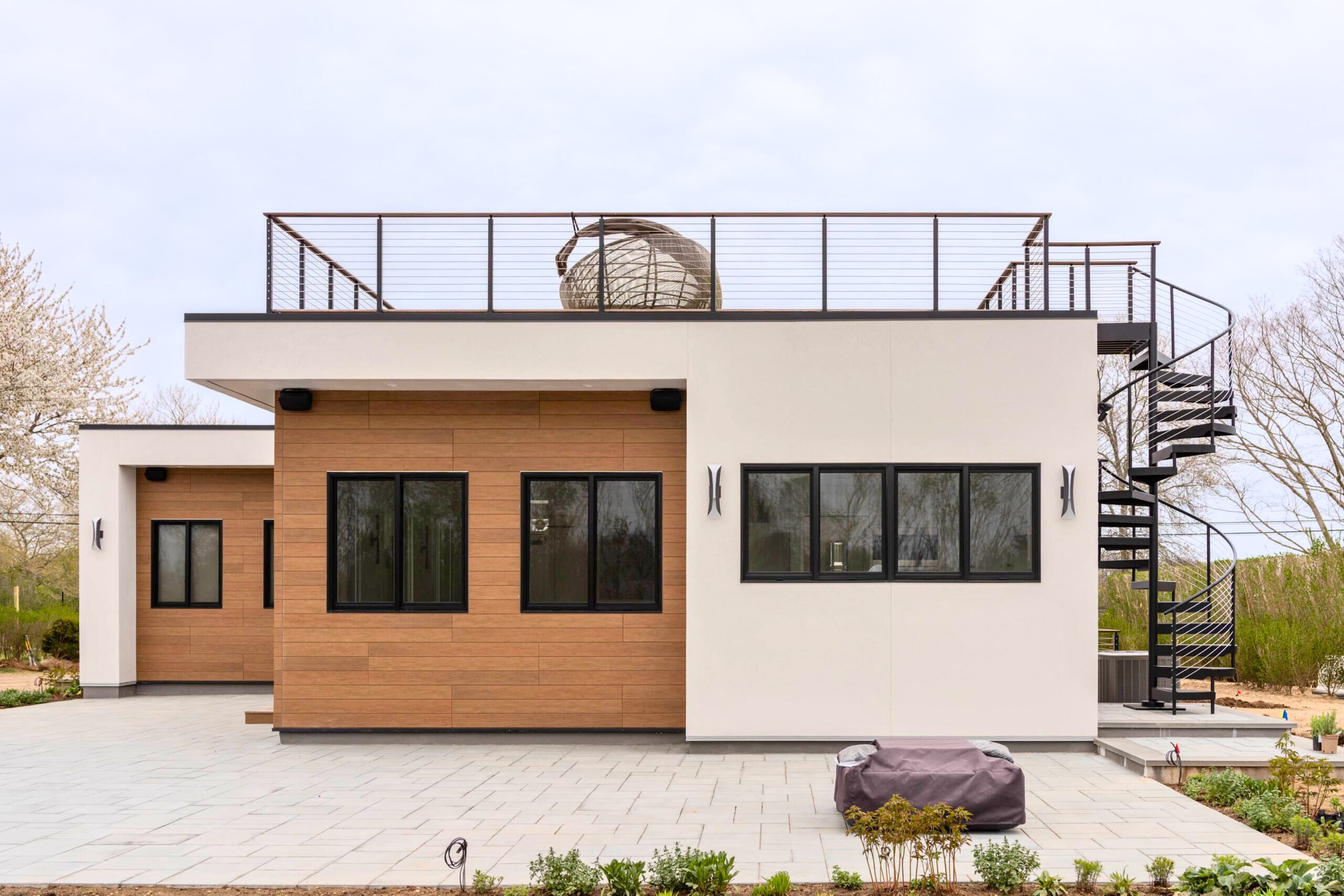 Front View of the house, showing the rooftop railing and FLIGHT Spiral staircase on the right side.