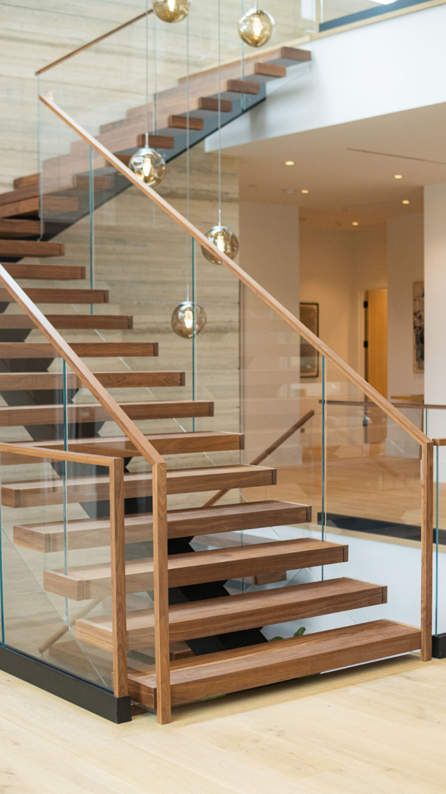 Floating staircase with wide treads and glass railing for safety