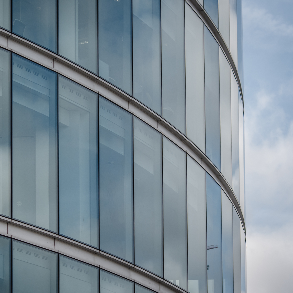 Curved exterior of large building that uses heat-strengthened glass