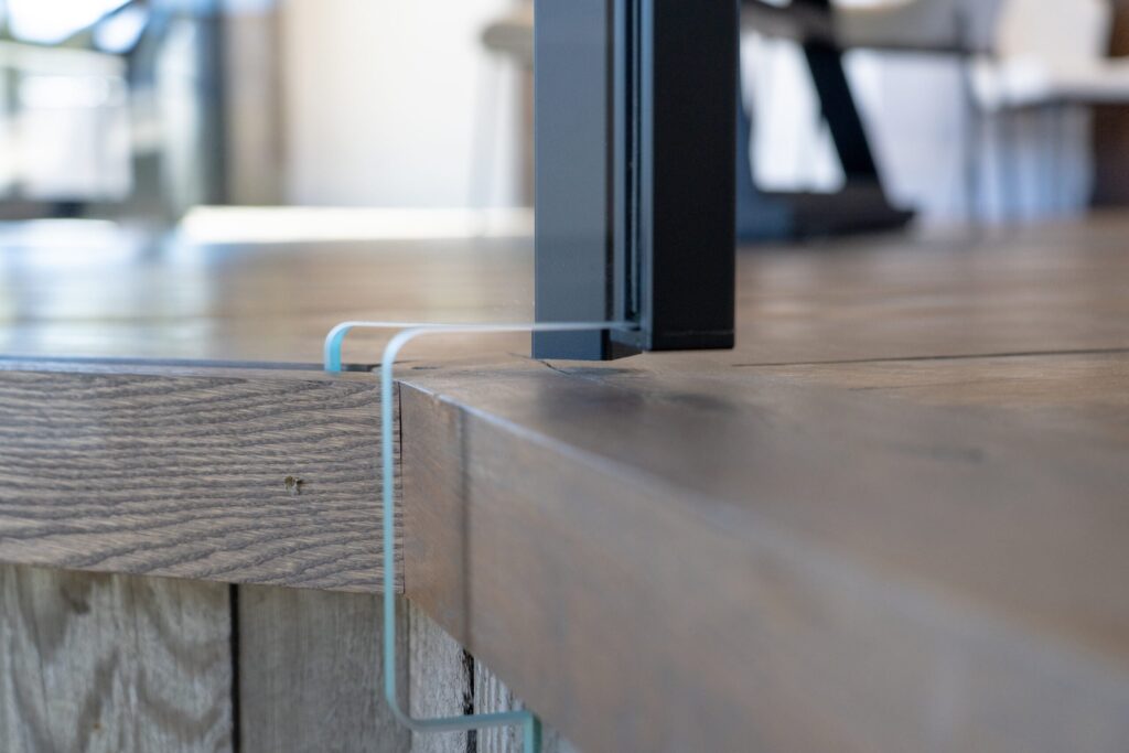 Close up view of Viewrail custom glass cut to go around a flooring edge.