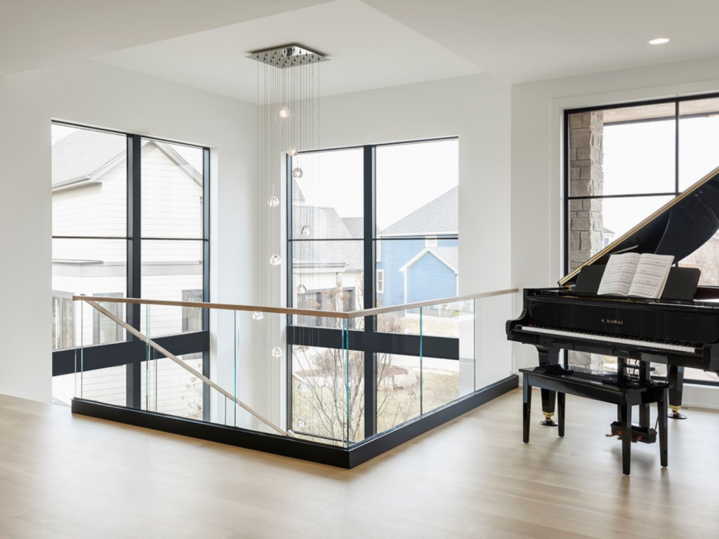 Viewrail glass base rail on a second floor transitions to a glass railing on the staircase.