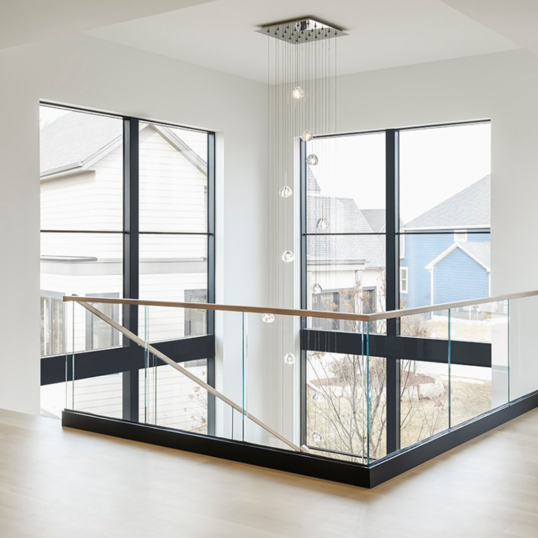 Viewrail glass base rail on a second floor transitions to a glass railing on the staircase.