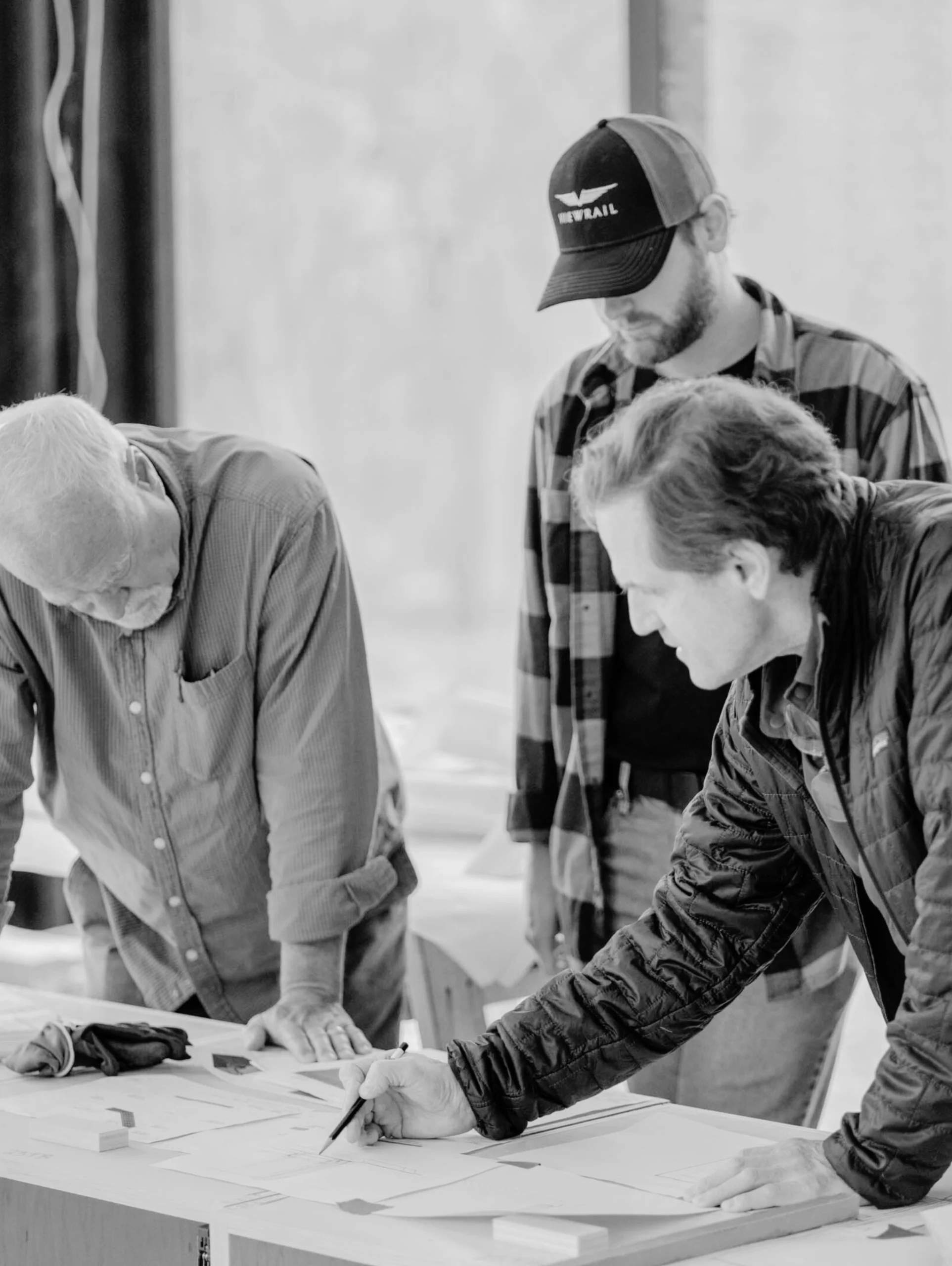A shot of Viewrail Certified Installers inspecting guides and drawings during a stair system installation.