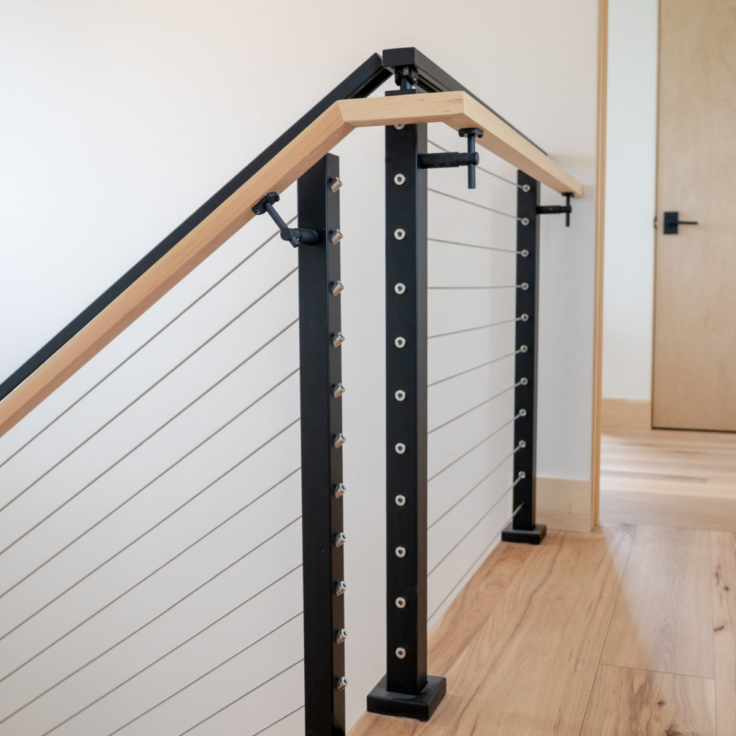 Interior Signature cable railing with secondary wood handrail on landing and stairs