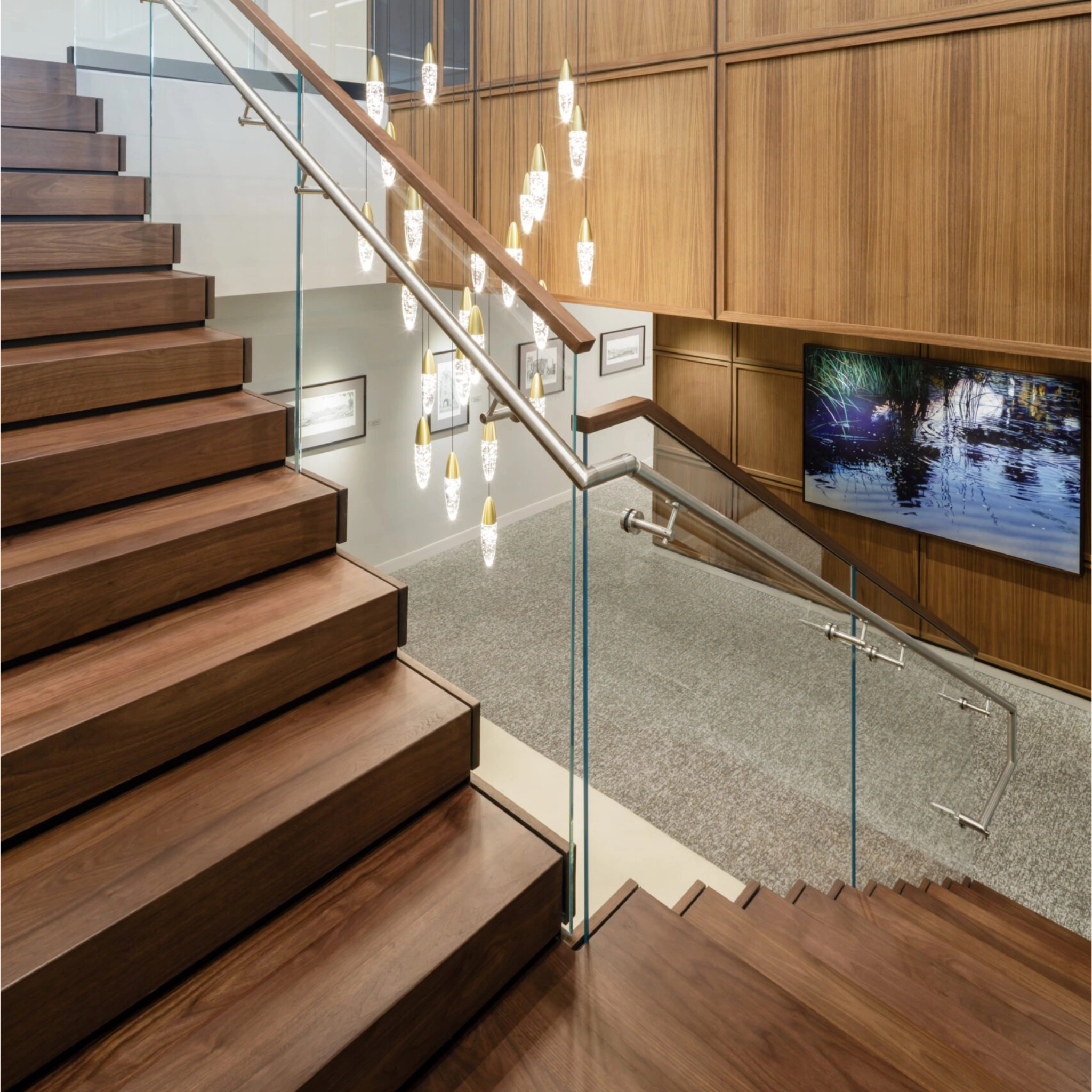 A 90° FLIGHT Stack makes a statement in an office building with Vedera glass railing and integrated, glass-mounted handrail.