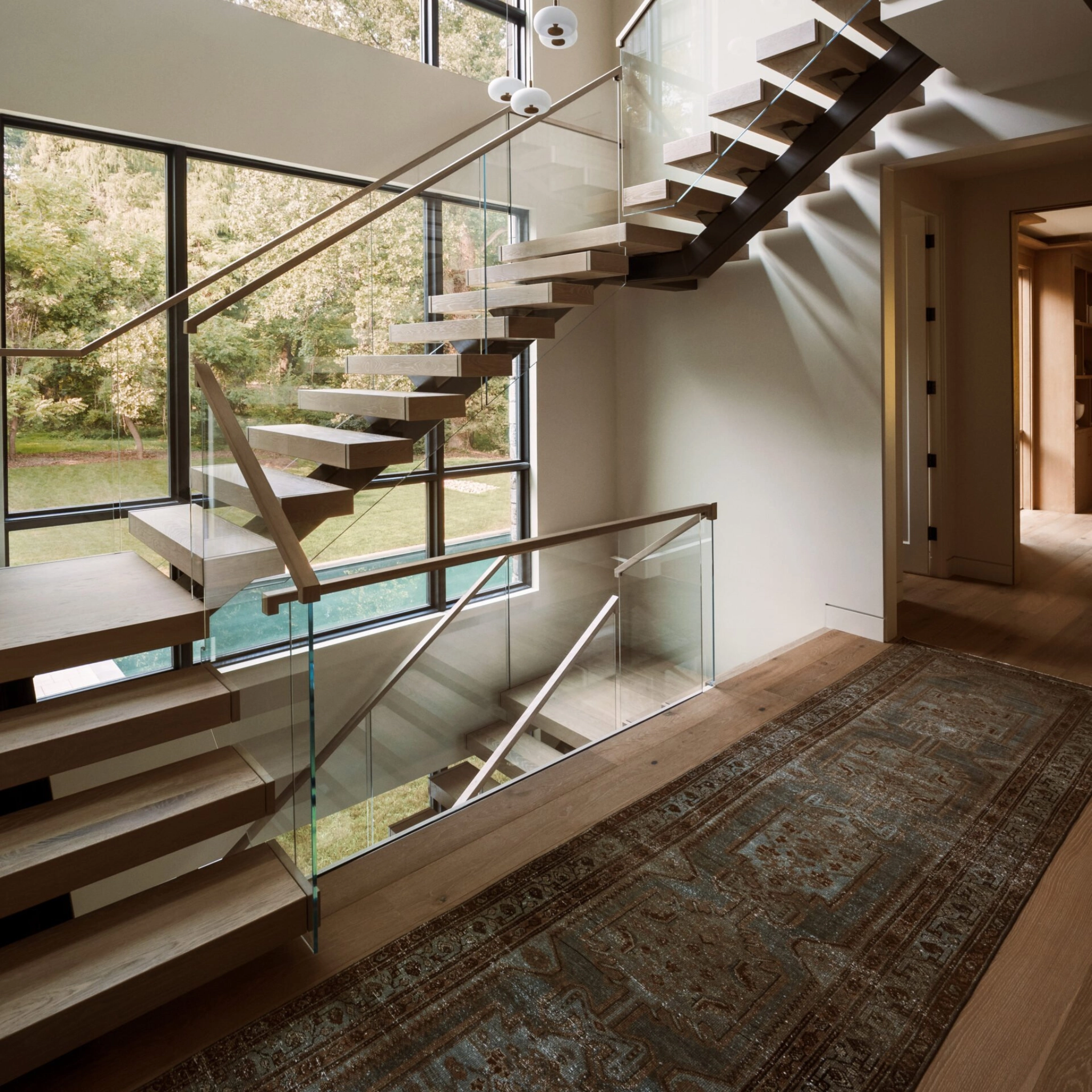 A FLIGHT Mono staircase in a U-Turn configuration with Vedera Glass railing.