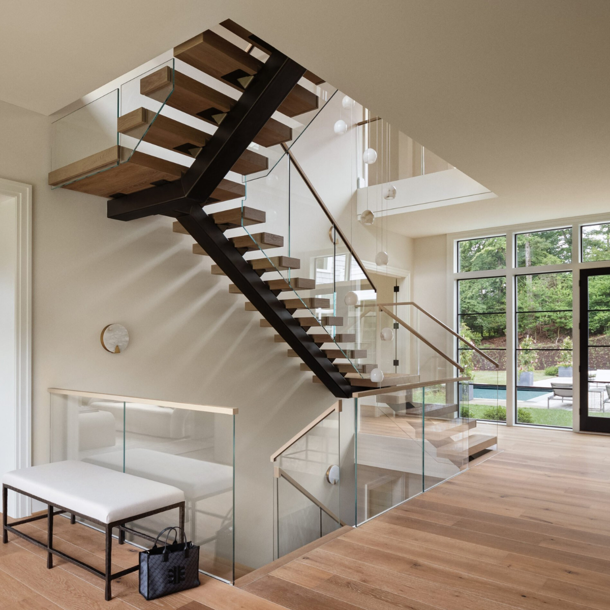 A soaring U-turn FLIGHT Mono stair system with Vedera glass railing.
