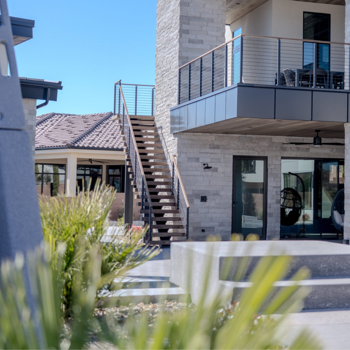 An exterior FLIGHT mono stair system with Signature Railing and stainless steel infill.