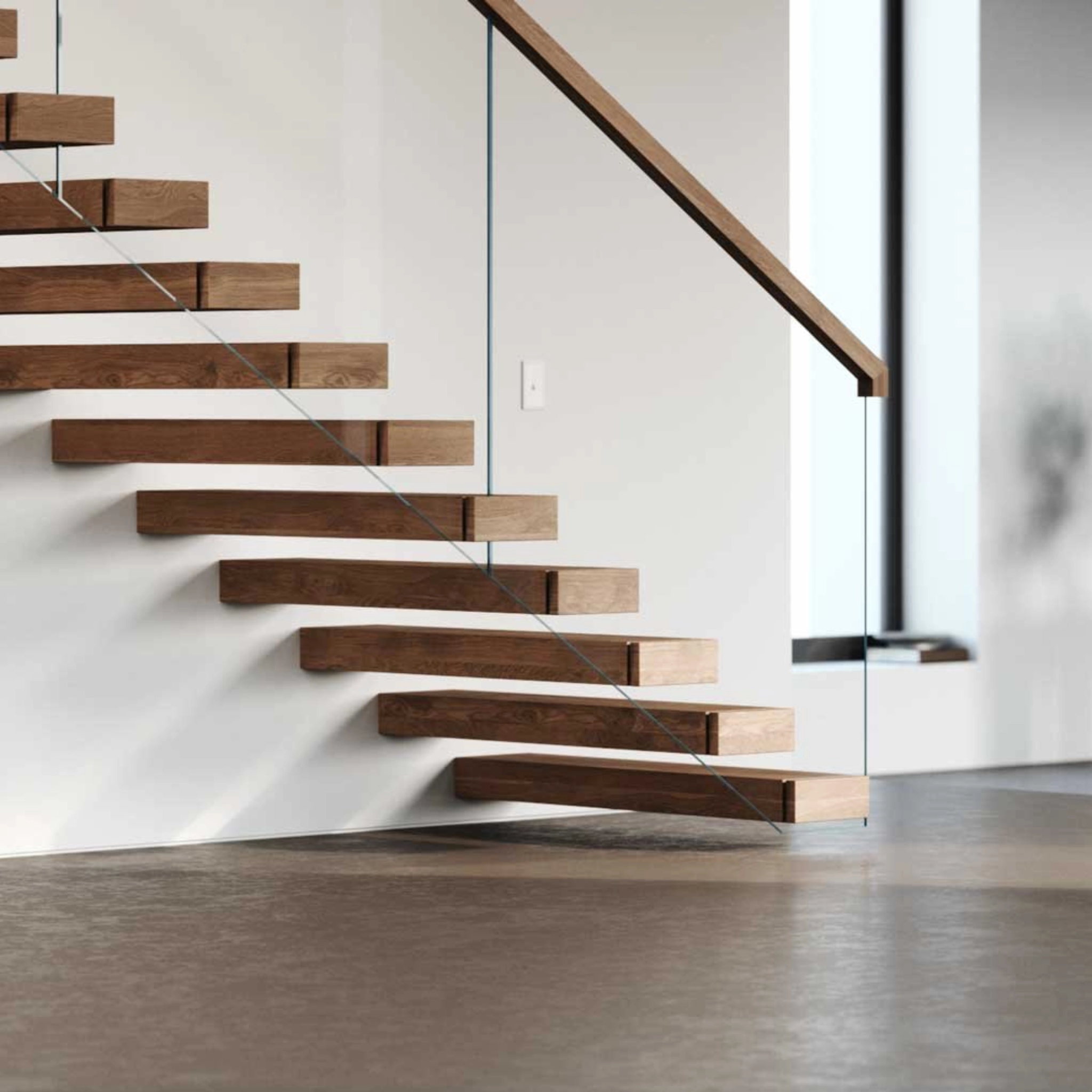 The lower portion of a FLIGHT Cantilever staircase shown against a white wall with tall windows.