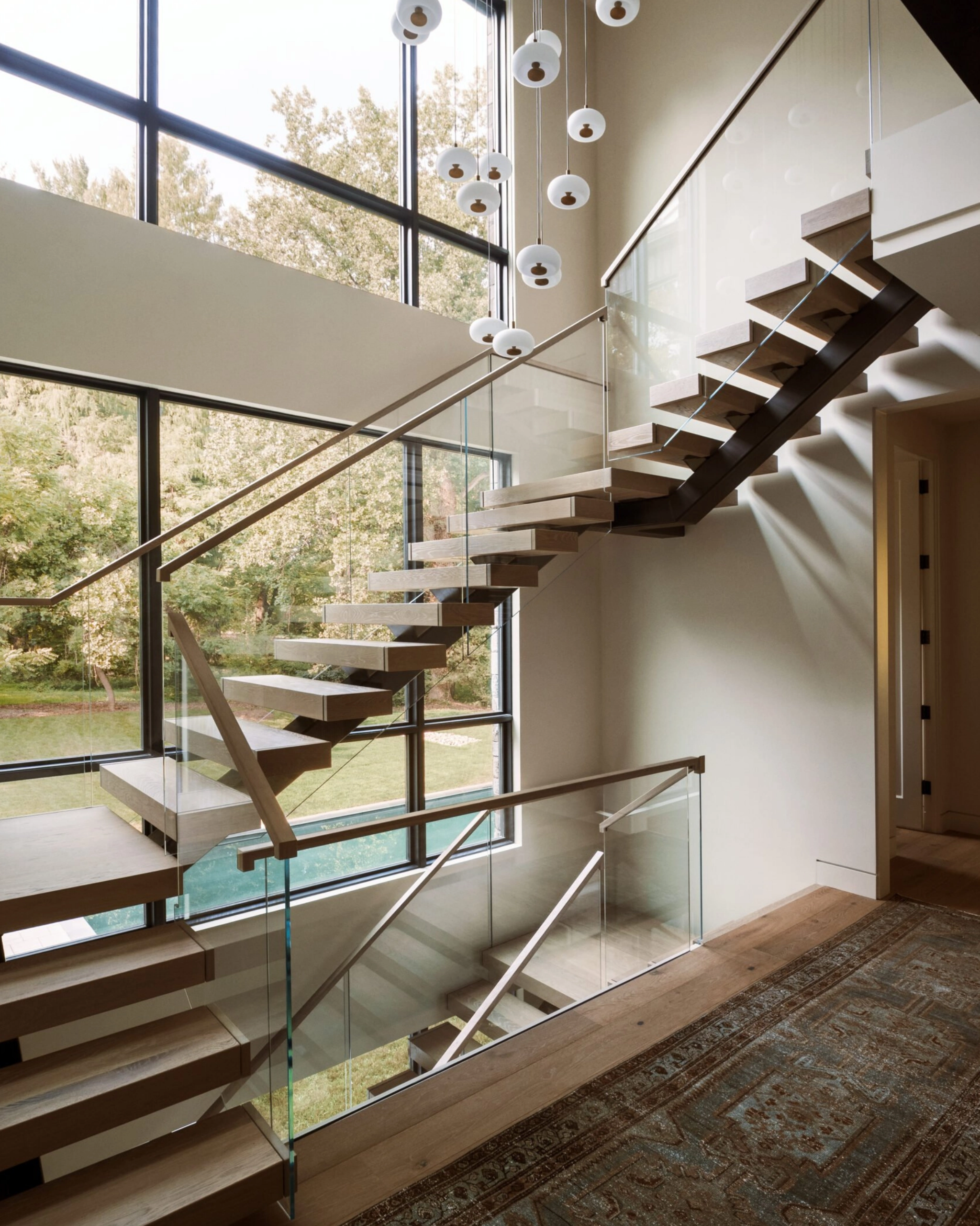 A soaring U-turn FLIGHT Mono stair system with Vedera glass railing.