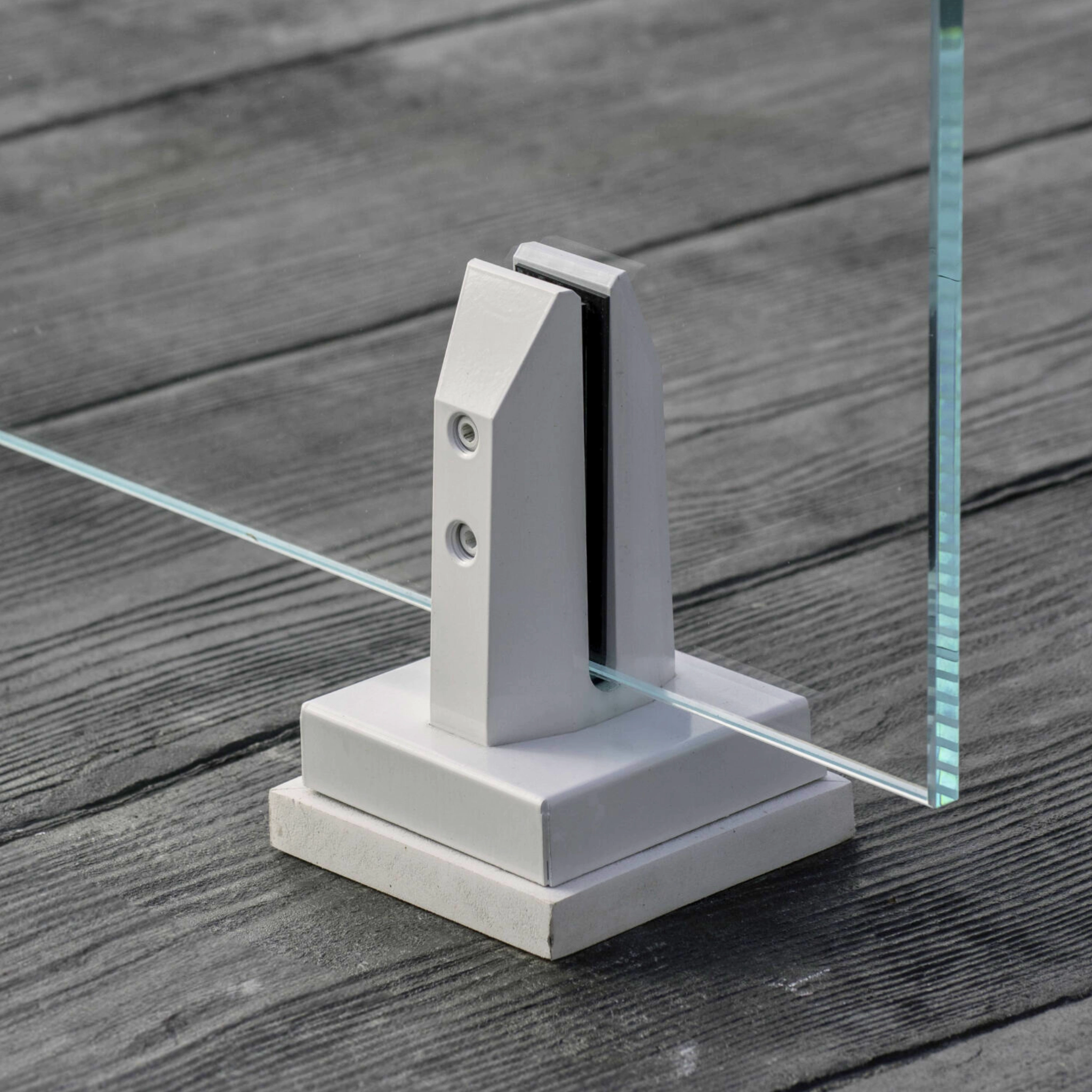 A close up of a white powder-coated Talon anchored to a wooden deck.