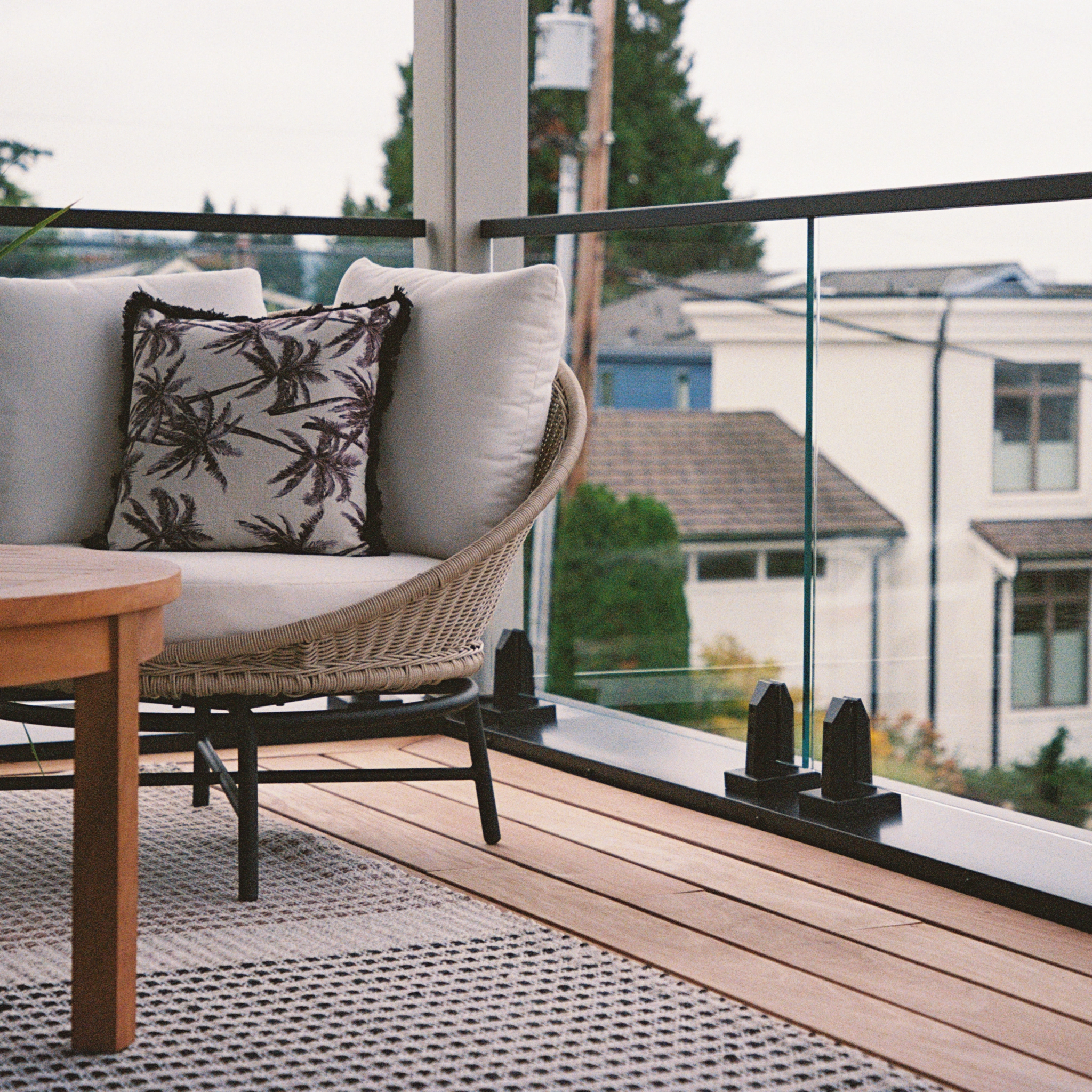 A black powder-coated Talon Spigot glass system with matching handrail graces a high balcony.