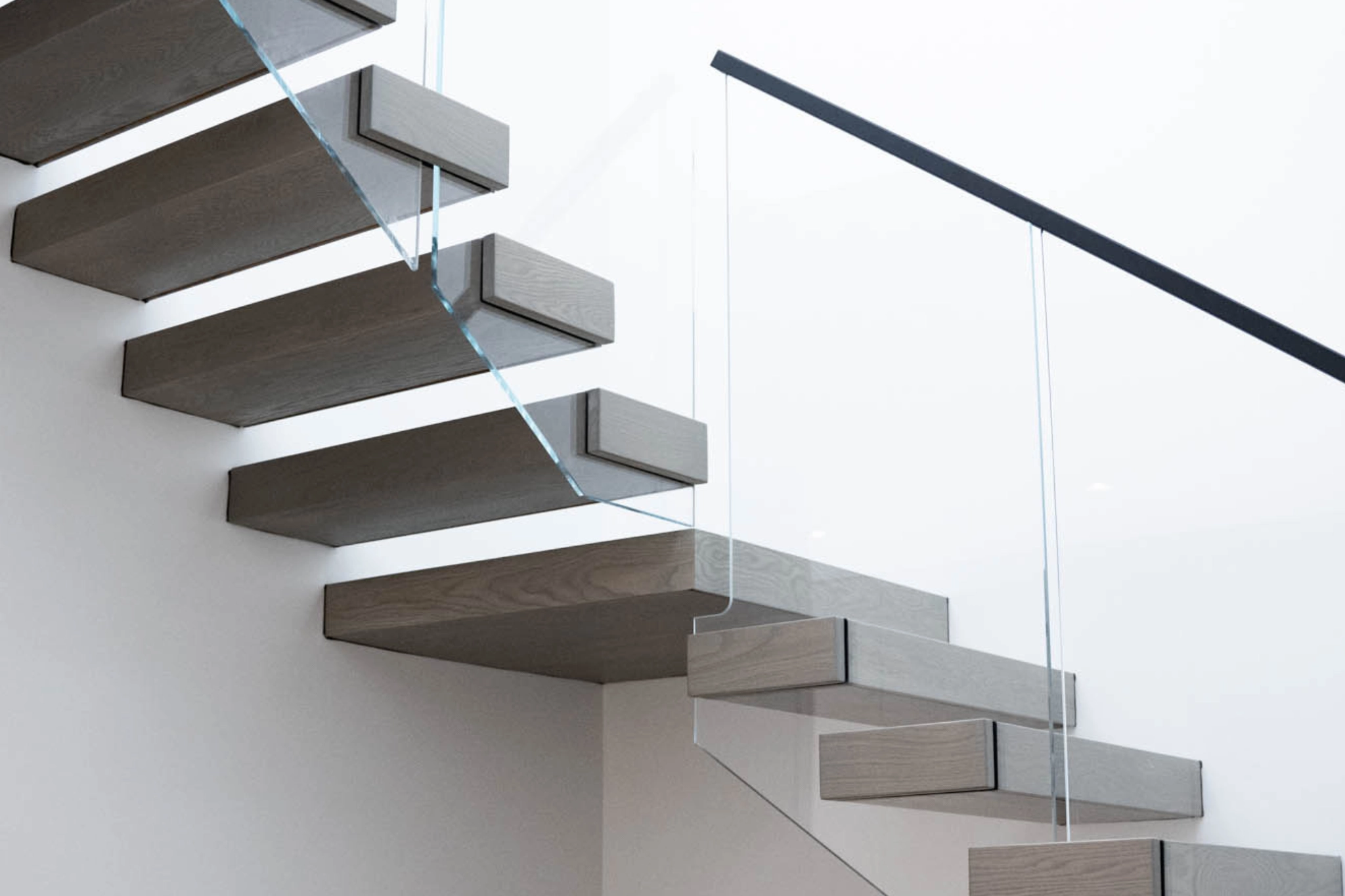 Vedera Glass Railing on FLIGHT Cantilever stairs.